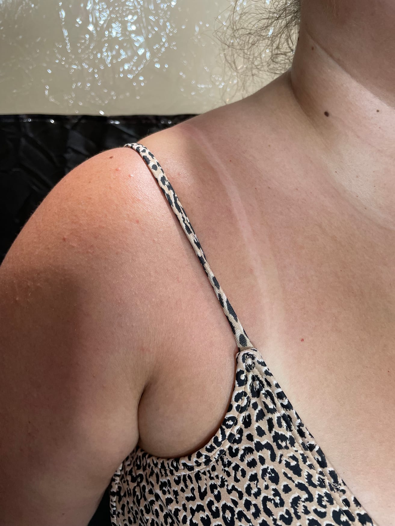Radiant, even spray tan across shoulders and collarbone