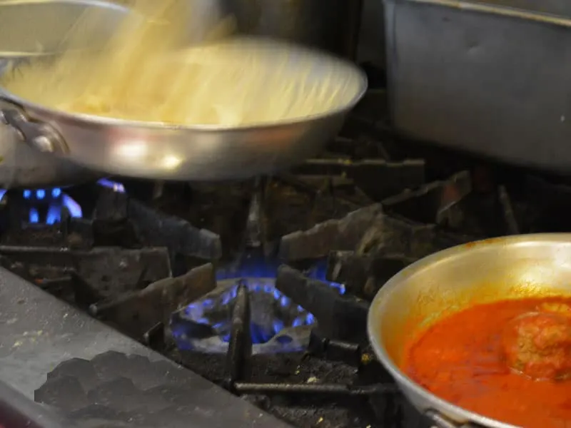 Alfredo cooking in the kitchen at Pizza al Bacio